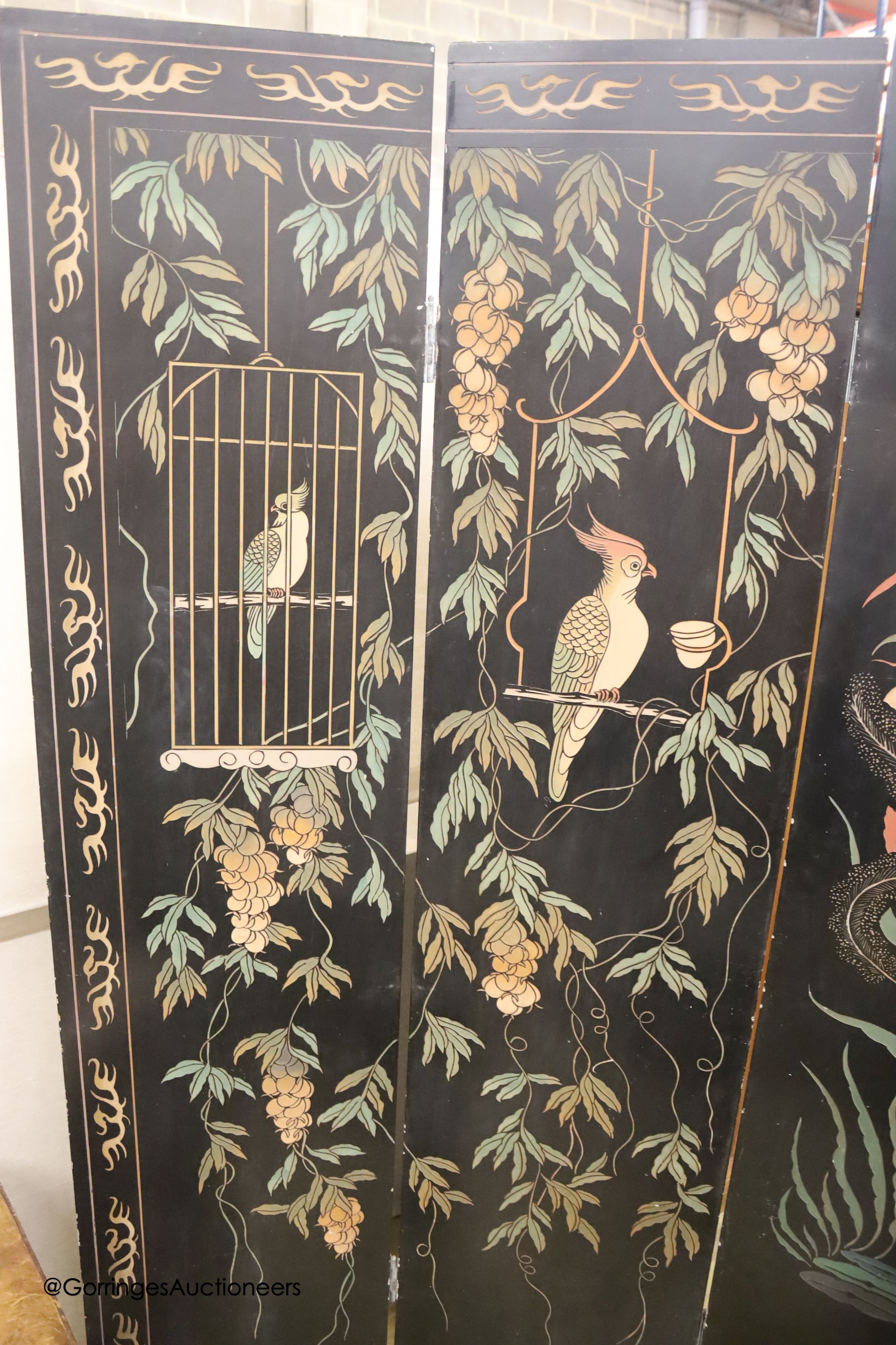 A Chinese ebonised four fold draught screen, painted each side with exotic birds and foliage, each panel width 40cm, height 187cm